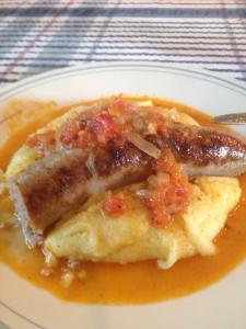 pork sausages smothered with tomato and onion
